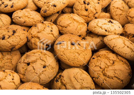 Cookies background. Chocolate chips biscuits texture background. Fattening sweets concept Cookies background. Chocolate chips biscuits texture background. Fattening sweets concept 135502305