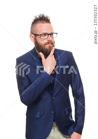 Young bearded man isolated at white background. Portrait of a confident stylish guy in eyeglasses looking at camera. Boy style, trendy hipster with cool hairstyle in blue suit. Young bearded man isolated at white background. Portrait of a confident stylish guy in eyeglasses looking at camera. Boy style, trendy hipster with cool hairstyle in blue suit. 135502327
