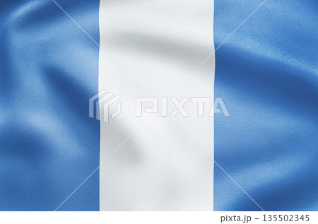 Elegant waving national flag of Guatemala with quetzal emblem and scroll. 135502345