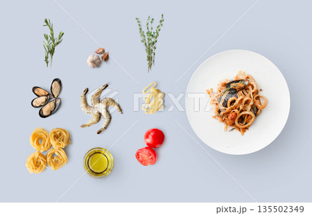 Cooking italian food, seafood pasta, isolated on blue. Frutti di mare with fettuccine spaghetti. Mussels, prawn, shrimp, calamari rings and other ingredients around plate with dish Cooking italian food, seafood pasta, isolated on blue. Frutti di mare with fettuccine spaghetti. Mussels, prawn, shrimp, calamari rings and other ingredients around plate with dish 135502349