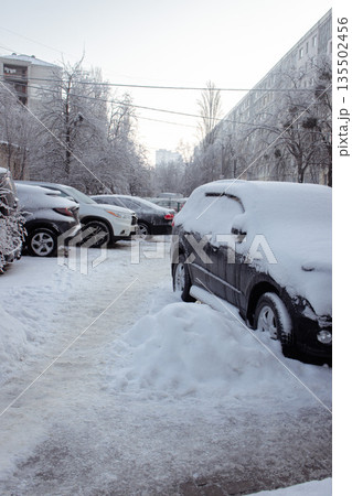 Cars covered with snow on the street. Frozen cars and trees in ice on backyard. Cold weather in big city. Frozen snow-capped auto. Winter snow storm. Cars with ice and frost. Downtown after snowfall. Cars covered with snow on the street. Frozen cars and trees in ice on backyard. Cold weather in big city. Frozen snow-capped auto. Winter snow storm. Cars with ice and frost. Downtown after snowfall. 135502456