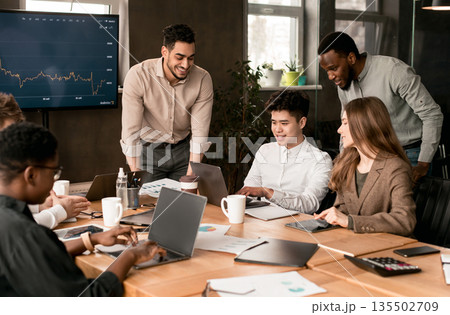 Teamwork, Lifestyle And Corporate Meeting Concept. Smiling Diverse Creative Group Working At Office, Having Breefing. Multiracial Colleagues Using Laptops, Looking At Screen, Making Project Together Teamwork, Lifestyle And Corporate Meeting Concept. Smiling Diverse Creative Group Working At Office, Having Breefing. Multiracial Colleagues Using Laptops, Looking At Screen, Making Project Together 135502709