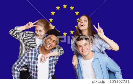 Group Of Happy Multi Ethnic Students Standing Over EU Flag Background, Cheerful Teens Enjoying Education In Europe Union, Panorama 135502721