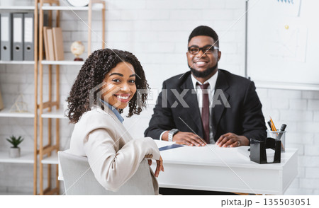 Smiling personnel manager and African American vacancy candidate on job interview in office. Panorama 135503051