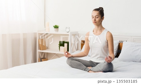 Morning Meditation. Woman Practising Yoga In The Morning, Sitting On Bed, Free Space 135503185
