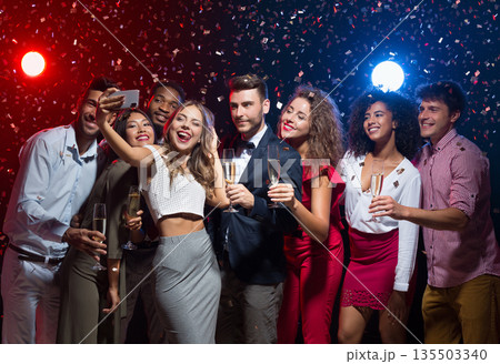 Holiday group selfie. Young friends having fun at New Year's Eve party and taking photo, copy space 135503340