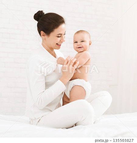 Happy time of motherhood. Young mother holding her cute baby, panorama with empty space 135503827