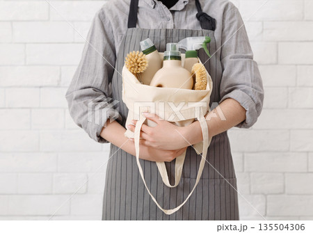 Unrecognizable woman holding Eco friendly products for home cleaning. Natural domestic cleaning, zero waste detergent 135504306