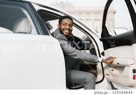 Car Rental. African American Businessman Opening Automobile Door Getting Out Of Auto In City. Car Rental. African American Businessman Opening Automobile Door Getting Out Of Auto In City. 135504644