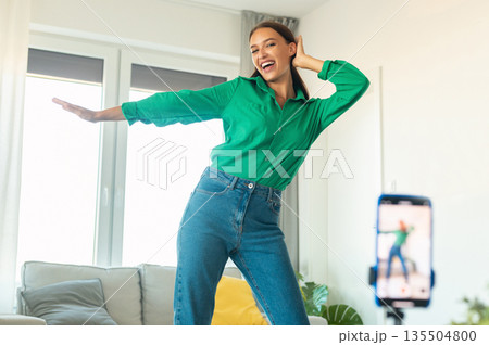 Professional Blogging. Joyful Blogger Woman Making Video Via Smartphone Having Fun Dancing And Posing At Home. Online Blog And Social Media Concept. Selective Focus 135504800