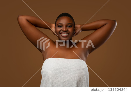 Love Yourself. Happy Chubby Black Woman Posing With Hands Raised Up, Showing Her Smooth Armpits, Cheerful African Female With Beautiful Skin Posing Wrapped In White Towel At Brown Studio Wall Love Yourself. Happy Chubby Black Woman Posing With Hands Raised Up, Showing Her Smooth Armpits, Cheerful African Female With Beautiful Skin Posing Wrapped In White Towel At Brown Studio Wall 135504844