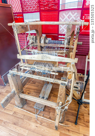 Weaving wooden machine or household weaving for weaving traditional linen. Weaving loom for homemade textile production 135505325