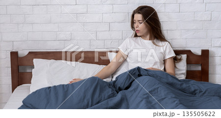 Unhappy young woman lost in sad memories, remembering her deceased husband, stroking his pillow on bed at home, copy space. Widow feeling lonely and depressed, suffering from loss of beloved man Unhappy young woman lost in sad memories, remembering her deceased husband, stroking his pillow on bed at home, copy space. Widow feeling lonely and depressed, suffering from loss of beloved man 135505622