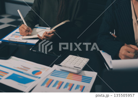 business people in meeting discussing plans together 135505957