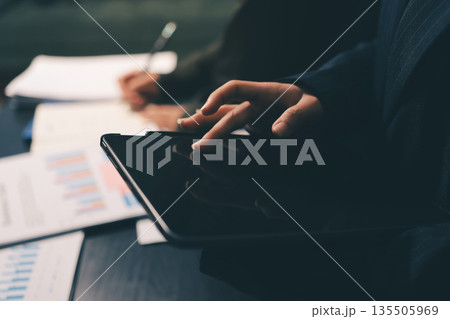 business people in meeting discussing plans together 135505969