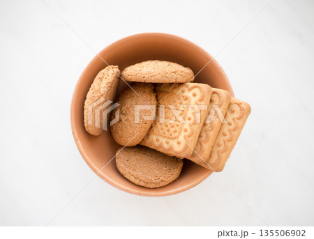 Biscuit in a plate on a marble background. Biscuit in a plate on a marble background. 135506902