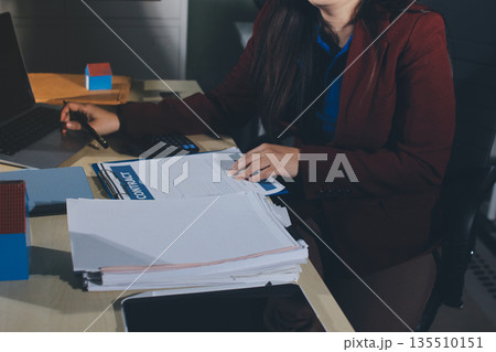Customer signing a real estate contract in real estate agency. Customer signing a real estate contract in real estate agency. 135510151