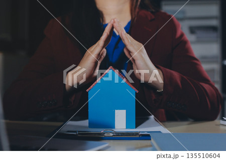 Customer signing a real estate contract in real estate agency. Customer signing a real estate contract in real estate agency. 135510604