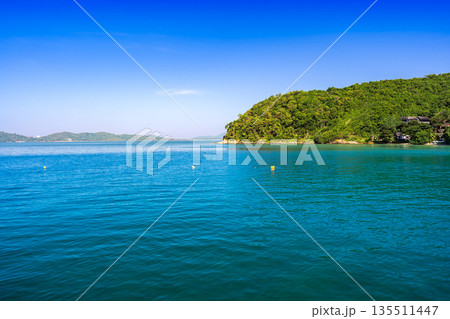 Panoramic view of the turquoise sea and lush green coastline of Koh Samed, Rayong, Thailand Panoramic view of the turquoise sea and lush green coastline of Koh Samed, Rayong, Thailand 135511447
