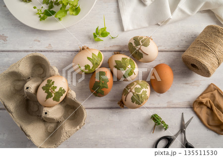 DIY Easter eggs with natural leaves, creating patterns on eggs using plants. Eco friendly colouring easter eggs DIY Easter eggs with natural leaves, creating patterns on eggs using plants. Eco friendly colouring easter eggs 135511530