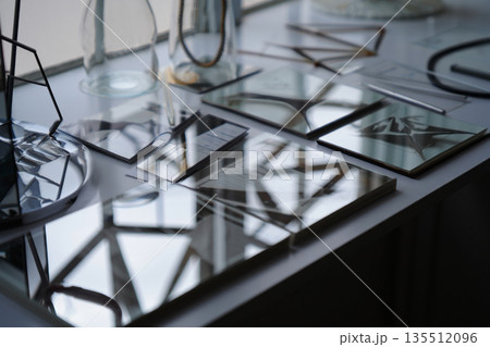 glass stainless steel plates on kitchen stove 135512096