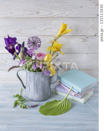 Floral still life with books and rustic charm, still life with spring flowers and folded books 135513830