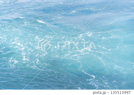 Clear turquoise waters of Prince Islands reflect sunlight as waves create soothing patterns along the shoreline, inviting relaxation and exploration. 135513997