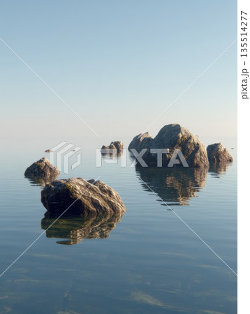 Rocks stand in still water, showing reflections while the open space and stone texture create a balanced scene under clear skies. 135514277