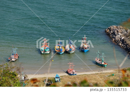 A bay with a boat mooring.View of the bay with turquoise water and colorful wooden fishing boats. 135515733