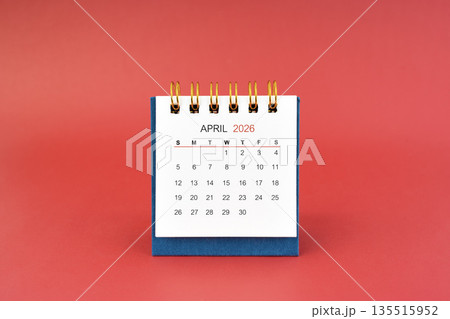 April 2026 white desk calendar on red background. April 2026 white desk calendar on red background. 135515952