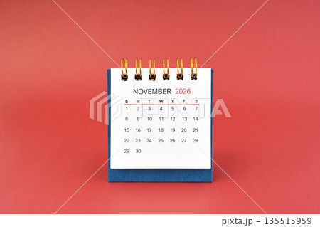 November 2026 white desk calendar on red background. November 2026 white desk calendar on red background. 135515959