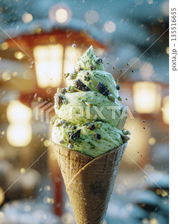 A single pistachio, mint green ice cream cone soft serve topped with chocolate pieces and nuts, held outdoors on a cold, snowy day with warm holiday lights and bokeh creating festive, sweet atmosphere 135516655