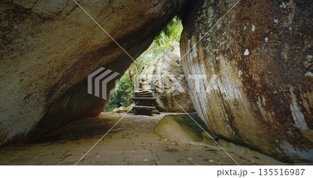 Serene Buddha Statue Nestled Among Enormous Rocks Serene Buddha Statue Nestled Among Enormous Rocks 135516987