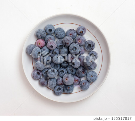 Frozen bog bilberry on a plate. 135517817