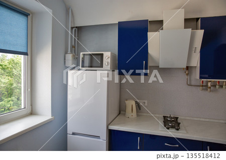 Modern kitchen with blue and white cabinets. Modern kitchen with blue and white cabinets. 135518412