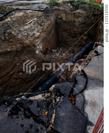 Road excavation exposing underground infrastructure 135518500