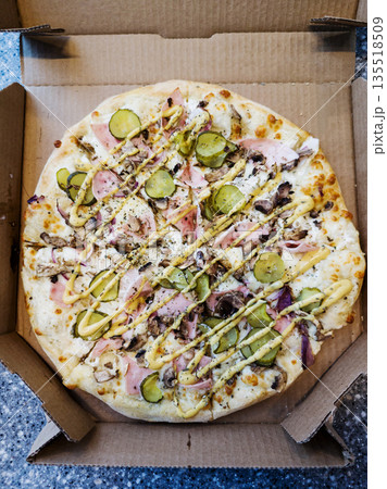 pizza in the cardboard box. 135518509