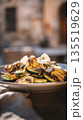 Appetizing food photography of perfectly charred, healthy, and flavorful grilled vegetables with rich cheese, beautifully plated for an al fresco dining experience in a sunny, rustic setting 135519629