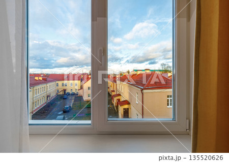 View through a white plastic window of an old town European street View through a white plastic window of an old town European street 135520626