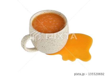 Pumpkin juice in a cup and on the table. Pumpkin juice in a cup and on the table. 135520692