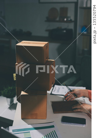 Startup, small business, SME owner check online orders. data logging Business growth, selling products, working with boxes. freelance work at home office online sme business small organization 135520794
