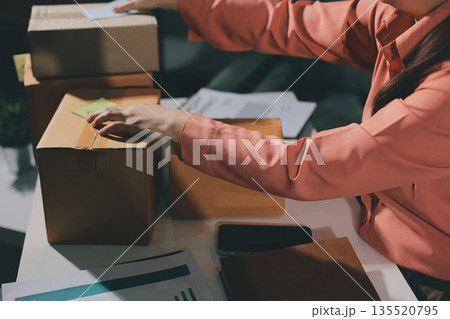 Startup, small business, SME owner check online orders. data logging Business growth, selling products, working with boxes. freelance work at home office online sme business small organization 135520795
