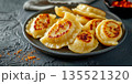 Close-up of fried Polish pierogi on black plate on dark background, dumpling with minced meat, traditional cuisine 135521320