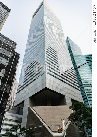 Skyscraper with glass. Modern glass building. Skyscraper in metropolis city. City downtown with skyscraper. Office building in business district. Skyscraper building architecture. City downtown 135521457