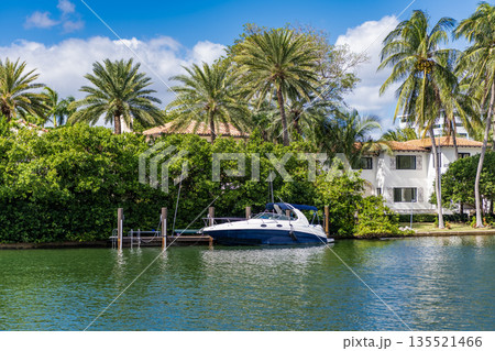 Yacht docked at vacation building in summer. Luxury waterfront house. Hotel building architecture. Modern building. Residential apartment in waterfront city. City waterfront with house Yacht docked at vacation building in summer. Luxury waterfront house. Hotel building architecture. Modern building. Residential apartment in waterfront city. City waterfront with house 135521466