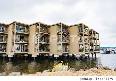 Building with residential apartment at the river. Harbor residential apartment building. modern architecture. Residential waterfront apartment building. Waterfront architecture 135521479