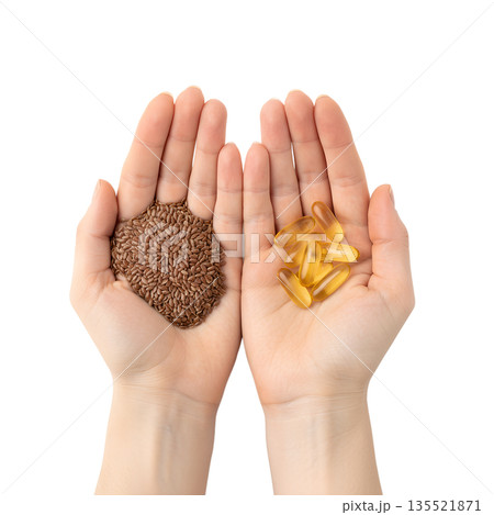 Nutrition comparison, handful of whole flax seeds vs. omega-3 supplement capsules in palms, isolated. For plant-based vs. marine omega-3 sources Nutrition comparison, handful of whole flax seeds vs. omega-3 supplement capsules in palms, isolated. For plant-based vs. marine omega-3 sources 135521871