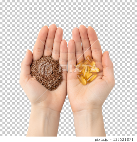 Nutrition comparison, handful of whole flax seeds vs. omega-3 supplement capsules in palms, isolated. For plant-based vs. marine omega-3 sources 135521871
