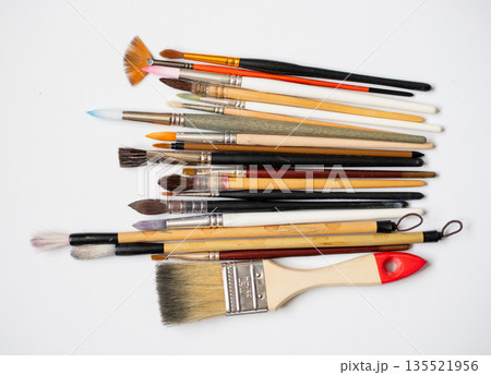 Different watercolor brushes collection isolated on white background, art supplies collection for painting, different sizes and shapes. Different watercolor brushes collection isolated on white background, art supplies collection for painting, different sizes and shapes. 135521956