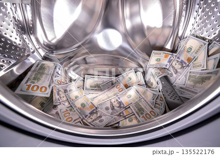 Dollar banknotes inside of washing machine Dollar banknotes inside of washing machine 135522176
